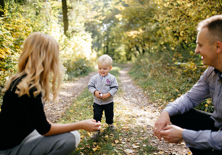 happy family playing and laughing in autumn park